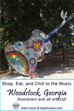 a colorful sculpture with words saying shop eat and chill to the music woodstock, georgia down town and all around