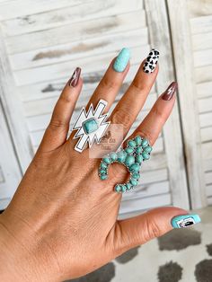 "Turquoise and silver Aztec ring Made with natural stone and brushed silver Measures: L 1.75\" x W 1\" This ring is adjustable! Gently pull or push the cuff to fit your fingerThis would make a great gift for the Western jewelry lover in your life!  Click here to be taken to our other rings: https://www.etsy.com/shop/CactusAndCoralInc?section_id=39978557 Click here to be taken to our Western chokers: https://www.etsy.com/shop/CactusAndCoralInc?section_id=39808176 Join us to be notified of new releases and exclusive discounts!  https://linktr.ee/cactusandcoral Thank you for stopping by. Have a blessed day! Sincerely, The Cactus and Coral Crew Western Stone and Silver Oval Statement Ring| Adjustable Big Southwestern Ring| Punchy Western Jewelry| Turquoise, White, Pink, Black Ring" Turquoise Western Nails, Nfr Nails, Punchy Western Nails, Western Chokers, Country Nail Designs, Western Nail Art, Nfr Rodeo, Country Acrylic Nails, Aztec Rings