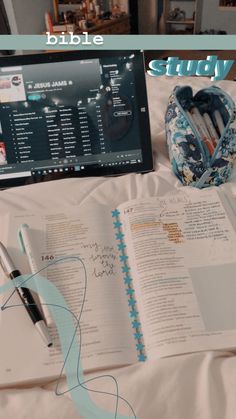 an open bible next to a laptop and pen on a bed with the words study in front of it