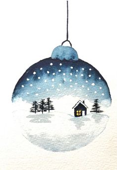 a christmas ornament with a house and trees in the snow, painted on watercolor paper