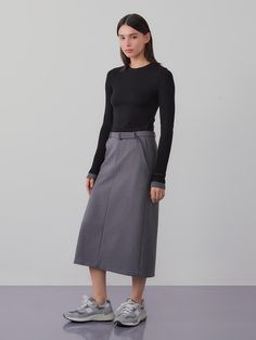 This product is a belted long skirt that exudes sophistication and modern style. The high-waisted design is accentuated with a belt, offering both elegance and a flattering fit. - The skirt features a sleek, straight cut that falls to mid-calf, providing a streamlined silhouette.- A built-in belt cinches at the waist, enhancing the skirt’s tailored appearance.- Made from a smooth, structured fabric, the skirt holds its shape while allowing for ease of movement.- Perfect for professional settings or dressy occasions, this skirt pairs effortlessly with both fitted and loose tops. Workwear Flared Skirt With Belt Loops, Modern Lined Maxi Skirt For Work, Modern Long Skirt For Workwear, Fall Workwear Skirt With Belt Loops, Chic Skirt With Belt Loops For Fall, Belted Skirt For Workwear In Fall, Relaxed Fit Skirt With Belt Detail For Spring, Relaxed Skirt With Belt Detail For Spring, Belted Skirt For Fall Workwear