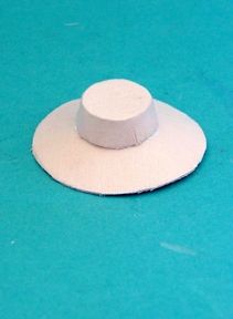 a white hat sitting on top of a blue table