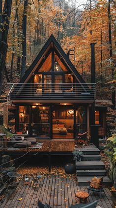 a small cabin in the woods surrounded by fall foliage and trees with yellow leaves on the ground