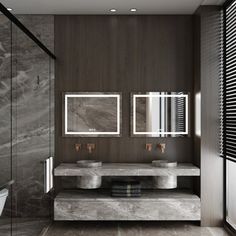 a bathroom with two sinks and mirrors on the wall