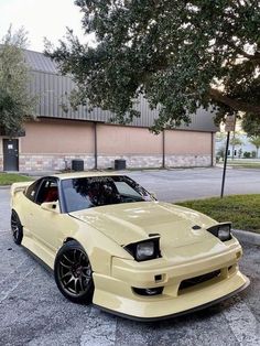 a yellow sports car parked in front of a building