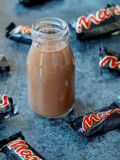 a jar filled with chocolate next to some candy bars