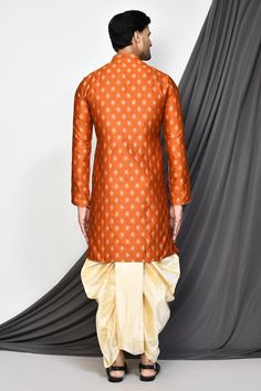 Orange full sleeve kurta with floral jacquard woven motifs and mandarin collared neckline. Paired with cream dhoti pant. - Aza Fashions Long Sleeve Sherwani With Zari Weaving, Transitional Long Sleeve Sherwani With Zari Weaving, Long Sleeve Traditional Wear With Zari Weaving For Festivals, Long Sleeve Sherwani For Puja With Traditional Patterns, Long Sleeve Sherwani With Zari Weaving For Diwali, Festive Traditional Wear With Long Sleeve Zari Weaving, Traditional Long Sleeve Sherwani For Puja, Festival Bandhgala With Zari Weaving And Long Sleeves, Traditional Long Sleeve Sherwani With Patterns