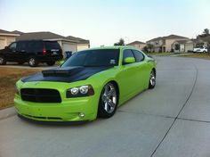 a bright green car parked in front of a house