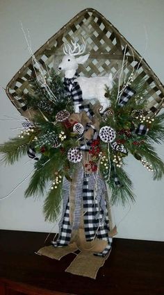 a christmas arrangement with deer and pine cones