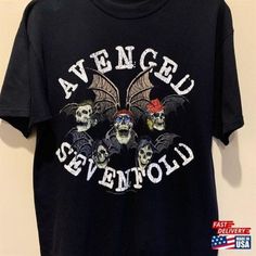 a t - shirt with skulls and bats on it that says avenuel sevenfold