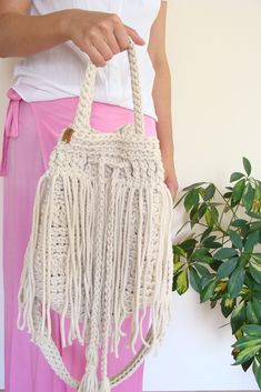 Boho fringe handbag. Cream Bohemian Hobo Bag For Summer, Summer Bohemian Cream Hobo Bag, Bohemian Bucket Bag With Braided Handles, Bohemian Macrame Shoulder Bag, Bohemian Straw Tote Bag With Tassels, Bohemian Cotton Bag With Braided Handles, Bohemian Handwoven Everyday Bucket Bag, Everyday Bohemian Handwoven Bucket Bag, Everyday Bohemian Macrame Shoulder Bag