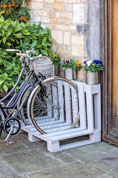 a bicycle is parked next to a planter