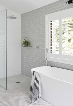 a white bath tub sitting next to a window