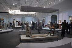 people looking at an exhibit in a museum