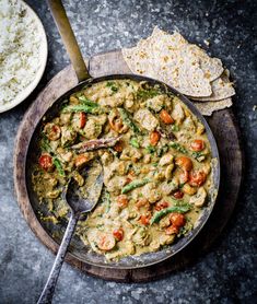 a pan filled with meat and vegetables next to tortilla chips