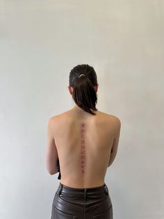 the back of a woman's body with chinese writing on her upper and lower back