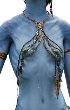 an image of a woman with blue skin and gold jewelry on her face, body and chest