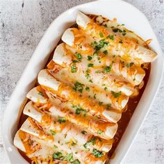 a casserole dish filled with chicken enchiladas