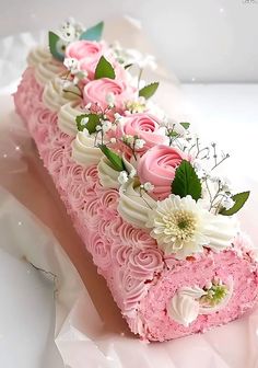 a piece of cake with pink frosting and flowers on it