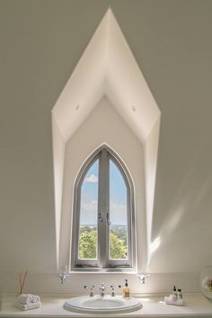 a bathroom with a large window above the sink