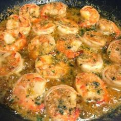 some shrimp and other food cooking in a skillet