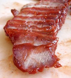 slices of bacon sitting on top of a cutting board