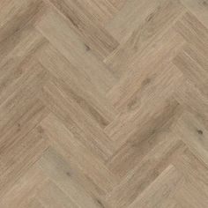 an image of wood flooring that looks like chevroned herringbones in light brown