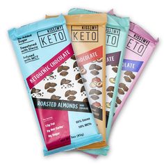 three bars of keto chocolate on top of each other in different colors and flavors