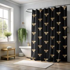 a bathroom with a black and gold bee shower curtain next to a white bathtub