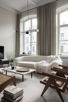 a living room filled with furniture and a flat screen tv sitting on top of a wooden stand