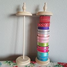 a stack of different colored ribbons sitting on top of a table next to each other