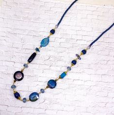 Long blue color beaded necklace designed with a mix of stone and glass beads.  It is made with various shape beads, gold plated beads, and gold plated caps on beads.  . A beautiful long necklace in light and dark blue colors that is perfect for any occasion.   Necklace length ~ 32 inches   The larger blue stone beads are 24 mm diameter and 24 mm x 20 mm Pull over necklace and no lobster claw. Finish ~ gold plated. Color Beaded Necklace, Beaded Necklace Designs, Dark Blue Color, Blue Tones, Blue Stone, Necklace Length, Necklace Designs, Beaded Necklaces, Stone Beads