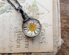 "Real daisy necklace by MARIAELA. Natural dried daisy behind glass. One of a kind. All of my jewellery is created in my home studio. Handmade with love ♥. Tifanny method - eco friendly tin. -Length of pendant 3.6 cm or 1.4 inches. -Stylized to old silver \"My true self is free. It cannot be contained.\" - Marcus Aurelius You are a great hunter if you have found me! I put my soul in what I do! If you would rather have flowers in your hair than diamonds on your neck - MARIAELA is the best choice f Handmade Daisy-shaped Jewelry Gift, Handmade Daisy-shaped Jewelry For Gift, Flower-shaped Soldered Necklaces For Gifts, Dainty Daisy Necklace For Gift, Flower Shaped Soldered Necklaces For Gifts, Flower Shaped Necklaces With Soldered Details For Gifts, Handmade Delicate Jewelry For Bridesmaid Gift, Handmade Flower Pendant Jewelry For Bridesmaids, Handmade Dainty Jewelry For Bridesmaid Gift