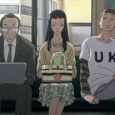 three people sitting next to each other in front of a laptop computer on a bench