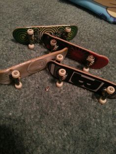 three skateboards laying on the ground with their wheels still attached to each other,