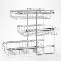 three metal baskets stacked on top of each other in front of a white background,