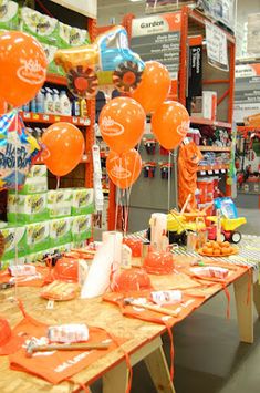 an orange table is set up with balloons