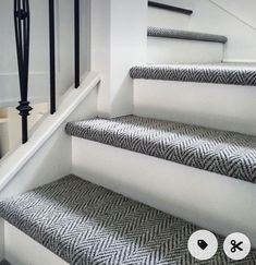 the stairs are decorated with black and white herringbone fabric, which matches the carpet