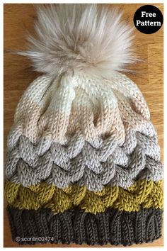 a knitted hat with two pom - poms sitting on top of it