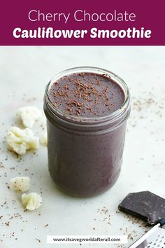 chocolate cauliflower smoothie in a mason jar next to a knife and spoon