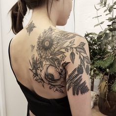 a woman with a flower tattoo on her back