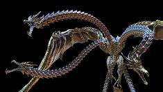 a metal dragon sculpture on a black background