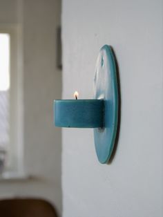 a blue candle is lit on the wall