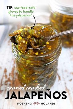 a jar filled with pickled jalapenos on top of a wooden table