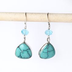 "These handmade earrings are of natural turquoise hand carved trillion cabochons bezel set in sterling silver. Above the turquoise is a bright blue faceted apatite bead. The earrings have a drop length of 1 1/2\" inch. Handmade in the USA. Dimensions: Each side of the triangle is 16mm. The apatite are 6mm. Drop length of 1 1/2\" inch. ❤️ Visit my shop: https://www.etsy.com/shop/JanPalomboDesign ❤️Click link below to see more earring designs: https://www.etsy.com/shop/JanPalomboDesign?section_id= Turquoise Faceted Drop Earrings, Turquoise Teardrop Faceted Earrings, Turquoise Faceted Teardrop Earrings, Faceted Turquoise Teardrop Earrings, Turquoise Teardrop Faceted Jewelry, Earring Designs, Silver Stacking Rings, Smokey Quartz, Natural Turquoise