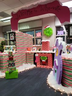 an office decorated for the holidays with candy canes and christmas decorations in front of it