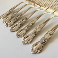 six antique silverplated forks and a comb