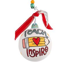 a white ornament with the words teach inspire written on it and a red ribbon