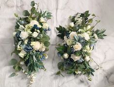 two bridal bouquets sitting on top of a white marble countertop next to each other