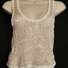 Size: Large New With Tag Washable 100% Rayon Crocheted Tank Top With Tiny Gold Tone Sequins Neckline, Armholes & Hem Are Solid Ivory/Cream Color Stretch Knit Great Alone Or As A Layering Piece From High End Nyc Boutique Please Note: Though Sized As Large, Top Appears To Run Small -- See Measurements. Some Stretch But The Top Is Delicate & It Should Not Be Pulled Too Tight. Chest: 29" (Unstretched) Center Back Length: 14.25" Hem Sweep: 34" Colors May Vary Slightly Due To Different Monitors. White Sleeveless Camisole For Party, White Party Camisole Vest, White Party Vest Camisole, Sequin Sleeveless Tank Top For Summer, Sleeveless Sequin Tank Top For Summer, White Sleeveless Party Top, White Tank Top For Party, Chic Fitted Crochet Tank Top, Spring Sequin Sleeveless Camisole